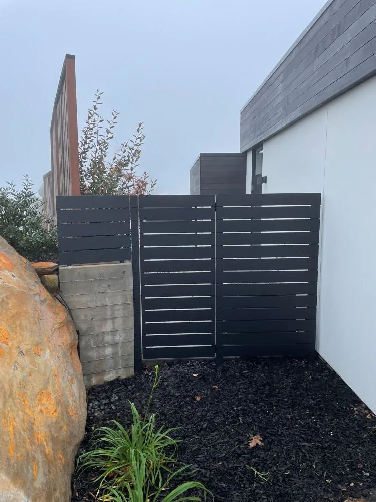 Arched walk gate in a timber fence