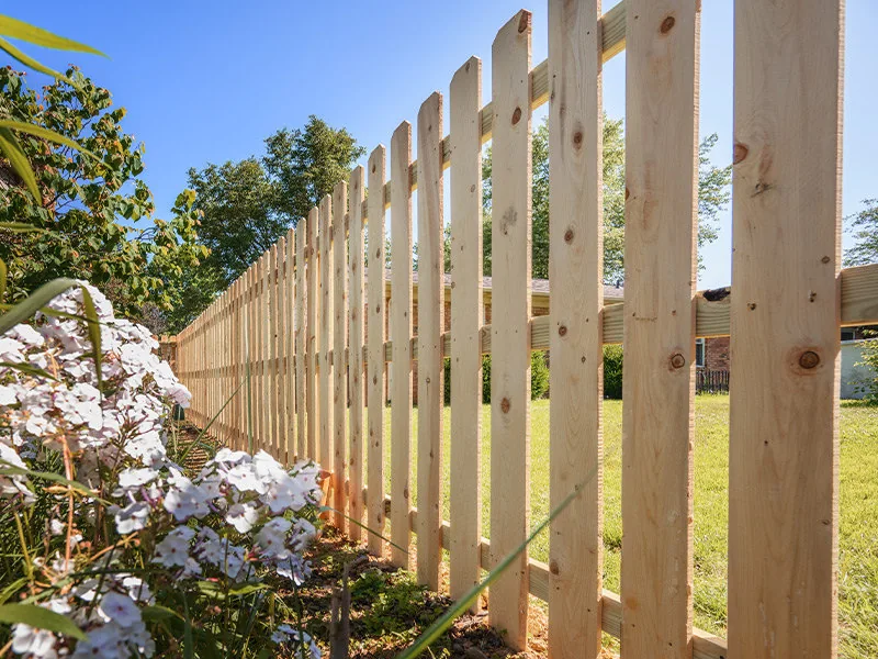 Weathered wood fence after restaining